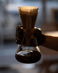 Close-up of hand holding coffee cup