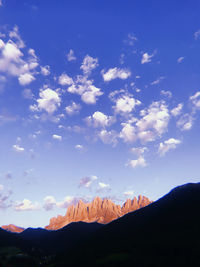 Scenic view of mountains against blue sky