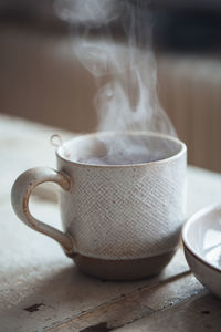 Close-up of steaming hot beverage in cup