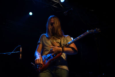 Rear view of person playing at music concert