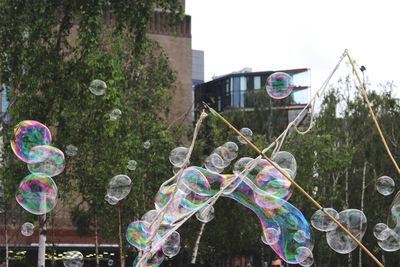 Bubbles formed with wand against buildings