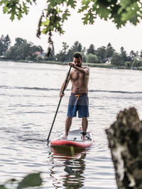 Man paddleboarding in lake
