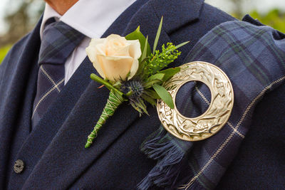 Close-up of man holding rose bouquet