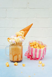 Close-up of ice cream and popcorns on table