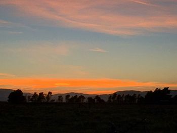 Silhouette landscape against sky during sunset