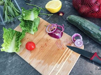 High angle view of lettuce and vegetables on cutting board