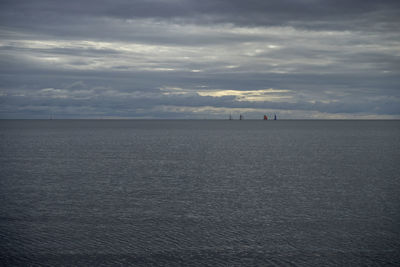 View of calm sea against cloudy sky