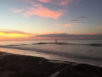 Scenic view of beach against sky during sunset