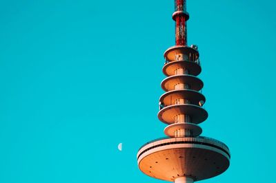 Low angle view of television tower against clear blue sky