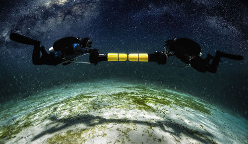 Men in water at night