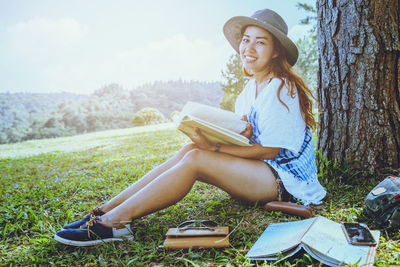 Young woman sitting on book