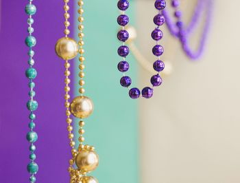 Close-up of multi colored necklaces hanging at home
