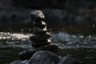 Stack of stones on rock at beach