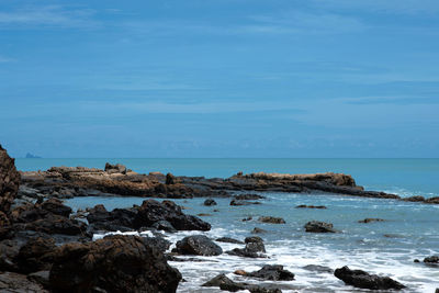 Rocks on beach against sky