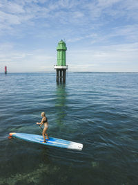 Young woman on stand up paddling board