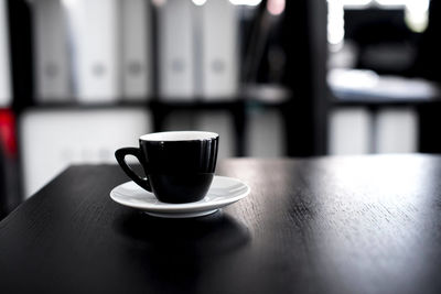 Close-up of coffee cup on table