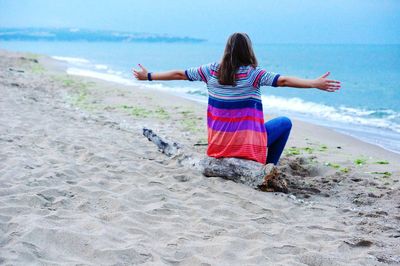 Rear view of woman walking on beach