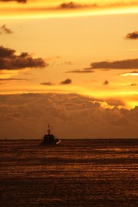 Scenic view of sea against orange sky