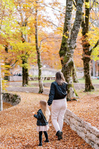 Rear view of woman walking in forest