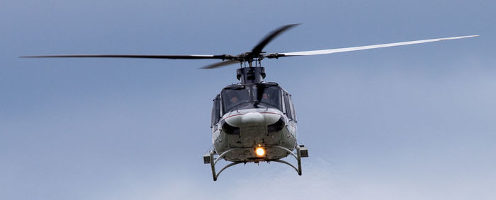 Low angle view of helicopter against clear sky