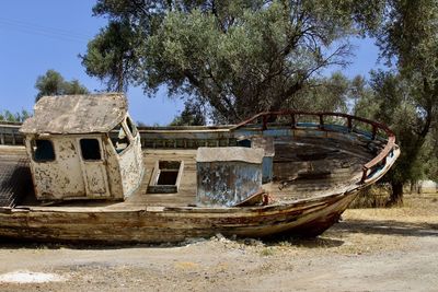 Abandoned boat against trees