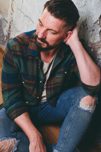 Young man sitting on chair