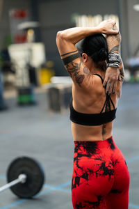 Rear view of young woman standing in gym