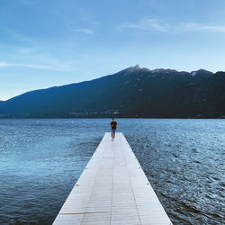 Full length of man standing on pier by lake