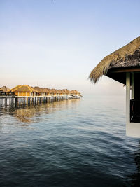 Scenic view of sea and houses against clear sky