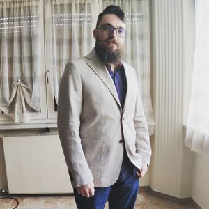 Portrait of young man standing against wall