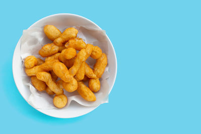 High angle view of food served in bowl against blue background