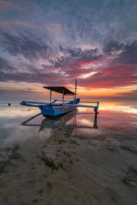 Scenic view of beach against sky during sunset