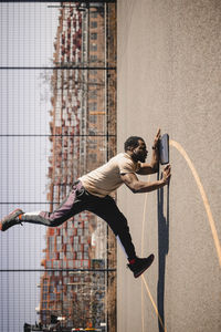 Full length of man skateboarding on city