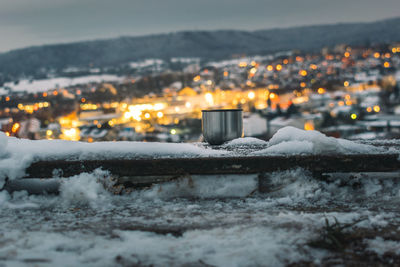 Illuminated buildings in city during winter