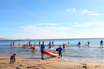 People paddleboarding in sea