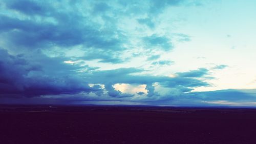 Scenic view of landscape against cloudy sky