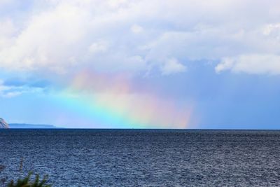 Rainbow over sea against sky