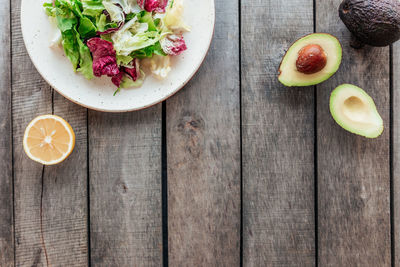 Healthy eating concept flat lay. mediterranean diet, plate with fresh green lettuce salad leaves