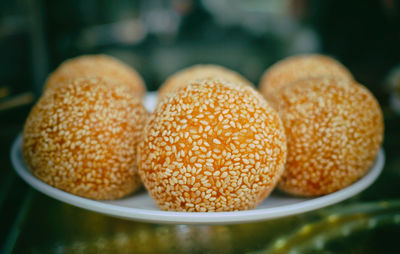 Close-up of 
sesame balls in plate on table