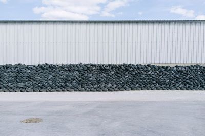 Stack of tyres piled up against wall