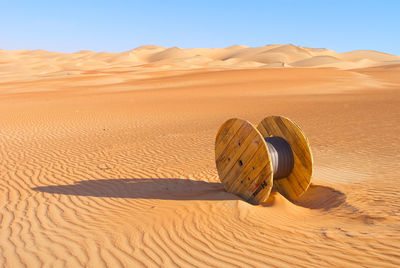 Sand dune in desert against clear sky