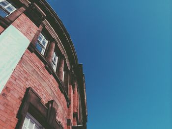 Low angle view of building against clear blue sky