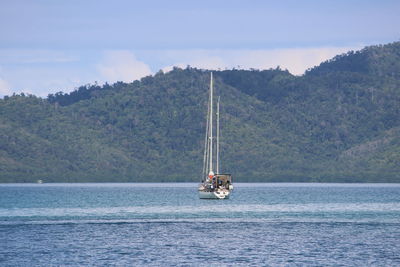 Boat sailing on sea against sky