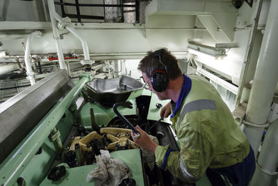 Side view of man working in factory