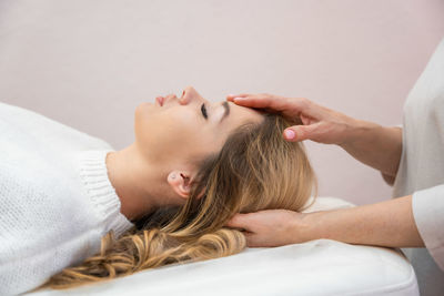 High angle view of woman lying on bed at home