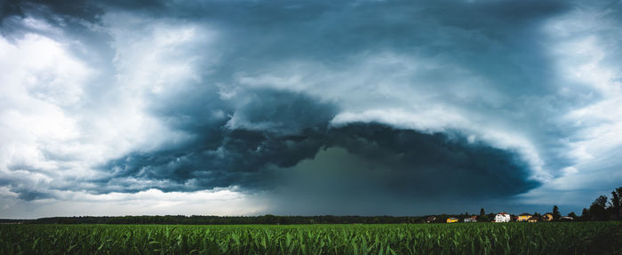 Scenic view of field against cloudy sky