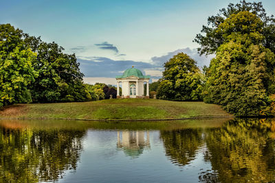 Scenic view of lake by building against sky