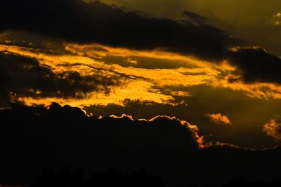 Silhouette of landscape against cloudy sky