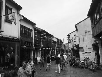 People walking on footpath in city