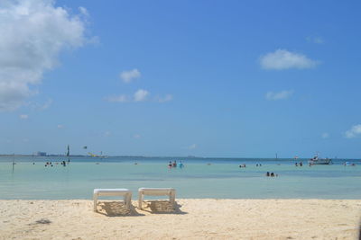 Scenic view of beach against blue sky